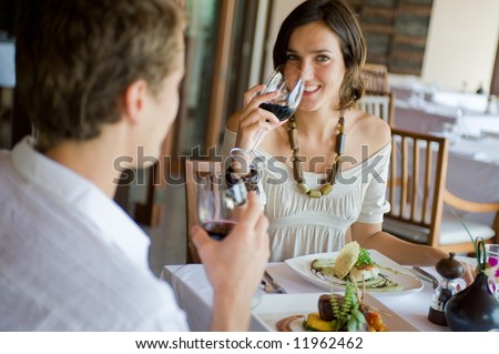 A young couple sitting together in a sophisticated restaurant Royalty-Free Stock Photo #11962462