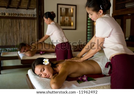A young couple receiving massage treatments together Royalty-Free Stock Photo #11962492
