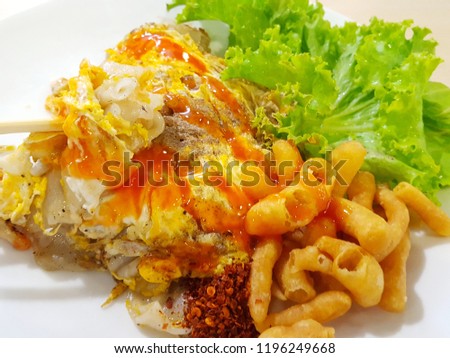 Stir Fried Noodles with chicken and egg. Thai fusion food served on white plate.Traditional asian food. Soft focus,Select focus