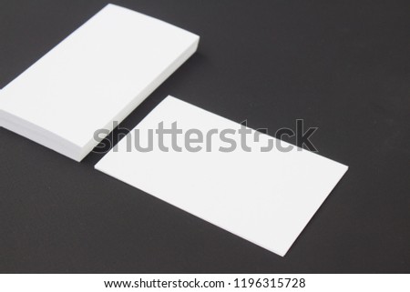 Photo of two business cards stack at black craft textured paper background . Template for branding identity.