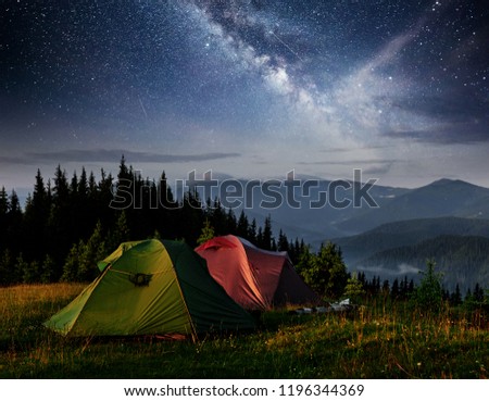 Dairy Star Trek above the tents. Dramatic and picturesque scene at night mountains. Carpathian Ukraine Europe.