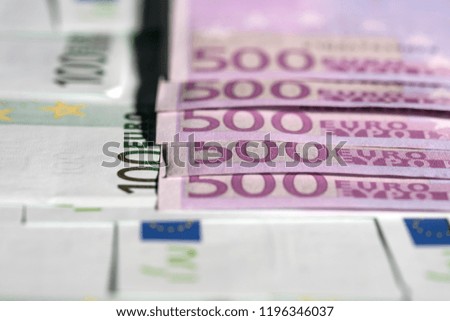 European euro currency bank notes lying on a desk close-up, symbolizing finance and business