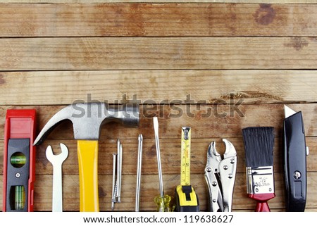 Assorted work tools on wood Royalty-Free Stock Photo #119638627