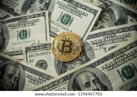 Golden Bitcoins Coins lying on dollars.