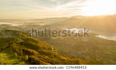 great sunrise behind a huge mountain in Austria with a amazing lake in the foreground, amazing sunrise in the nature of the Austrian alps, drone wildlife photography, fall season in austria