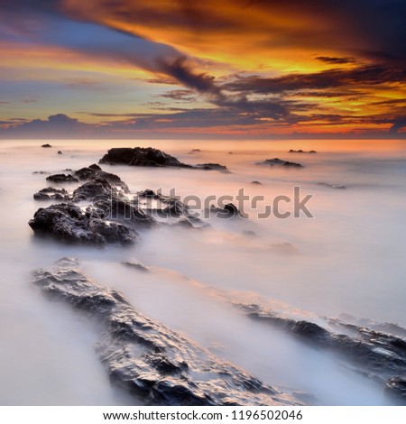 Tropical rocky beach at sunrise ( long exposure photography), Soft effect due to long exposure shot.
