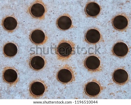 rusted metal surface With holes. Steel plate penetrated pattern.