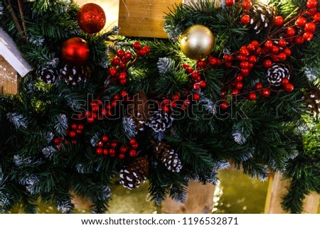 Christmas decorated fir branches with cones, berries, balls