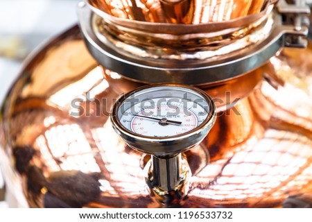 The thermometer on a copper pot for distillation of alcohol Royalty-Free Stock Photo #1196533732