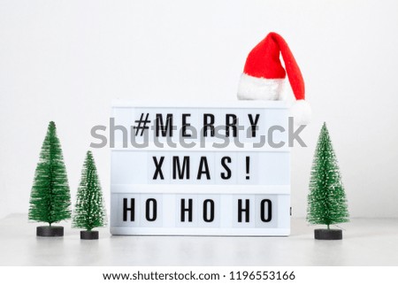 Christmas greeting card mock up. Light box with the text Merry Xmas and Christmas decoration. Seasons greetings concept