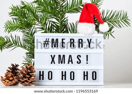 Christmas greeting card mock up. Light box with the text Merry Xmas and Christmas decoration. Seasons greetings concept