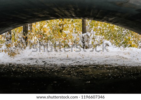 Fresh fallen snow under a bridge in the fall