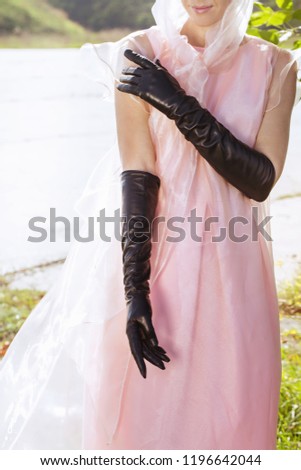 Young woman in beautiful long black gloves