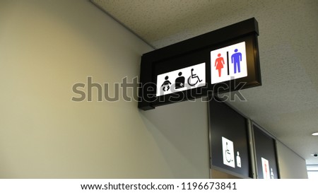 Toilet or restroom sign and symbol for woman, man, disabled person and baby at airport or mall