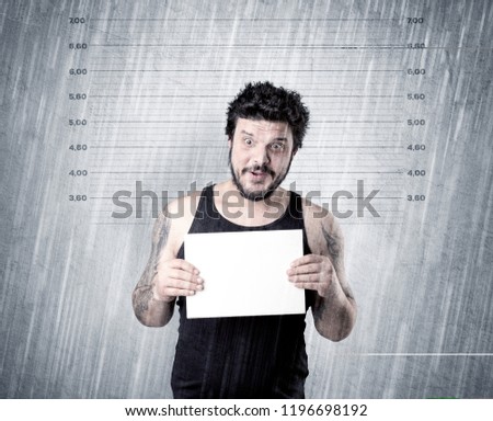 Gangster with rainy, lowering background and table on his hand.