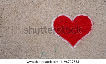 Heart shaped graffiti on a concrete wall