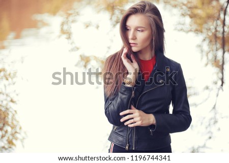 Young girl in autumn in rainy weather

