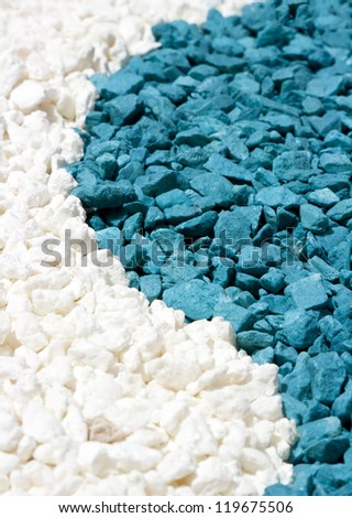 A closeup of colorful white and blue stones sand