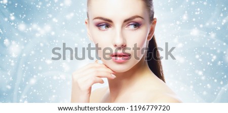 Portrait of young, beautiful and healthy woman over winter Christmas background. Royalty-Free Stock Photo #1196779720
