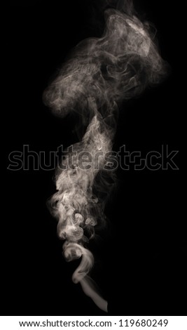 Abstract smoke swirls over the black background