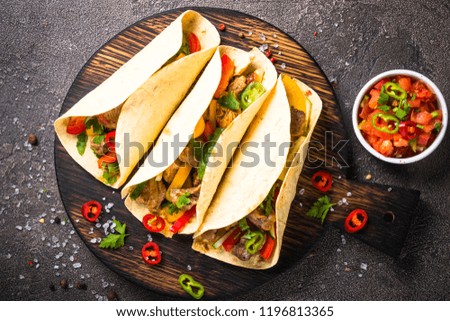 Mexican pork tacos with vegetables and salsa. Traditional Latin american food. Top view.