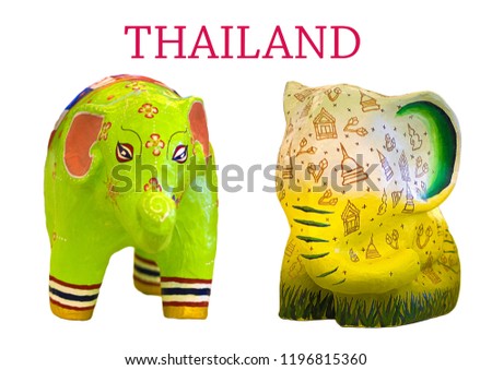 green light elephant statue with flag of Thailand at eyes and legs, yellow elephant statue with temple painting on it  on white background