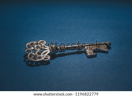 Vintage key close up on blue background.