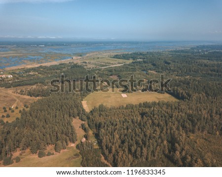 drone image. aerial view of rural area with fields and forests. textured background. sunny autumn day in latvia - vintage retro look - vintage autumn color look
