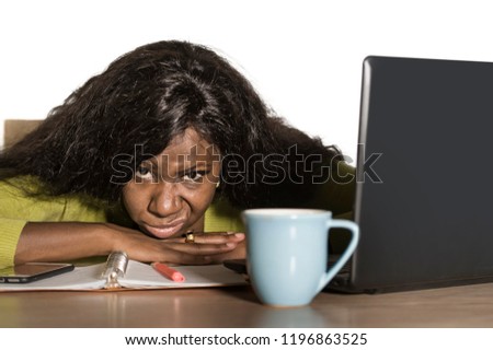 young attractive unhappy and exhausted black African American woman working lazy on Monday at office computer desk feeling overwhelmed bored and frustrated in business job problem