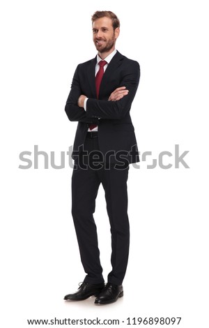 attractive businessman standing on white background with arms crossed looks to side, full body picture