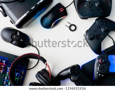 gamer workspace concept, top view a gaming gear, mouse, keyboard, joystick, headset and mouse pad on white table background with copyspace.