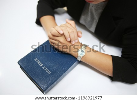 Woman holding a bible in her hands and praying. Christian life crisis prayer to god. Day of Prayer, international day of prayer, hope, gratitude, thankful
