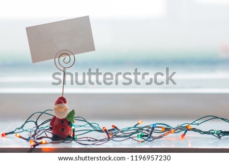 Christmas composition. Colorful garlands and Santa Claus with copy space card.