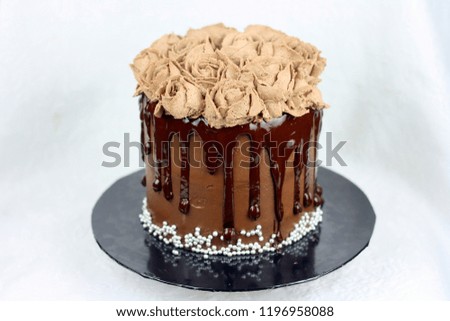 Chocolate cake with dripping choc and rose decoration