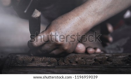 Hand of women with wood carving tools  to create handcraft art.