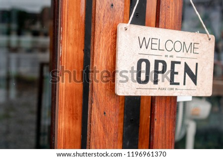 brown wooden doors with glass and orange  sign 