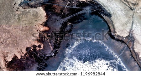 black beach,  black gold, polluted desert sand, abstract photo of the deserts of Africa from the air. aerial view, Genre: Abstract Naturalism, from the abstract to the figurative
