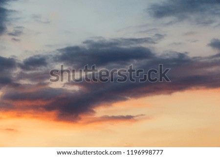 Textured clouds lit up by the sun during sunset