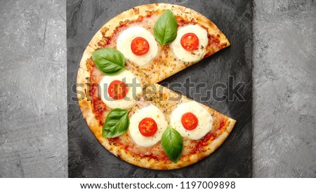 Homemade pizza with tomatoes, mozzarella and basil. Top view with copy space on dark stone table.