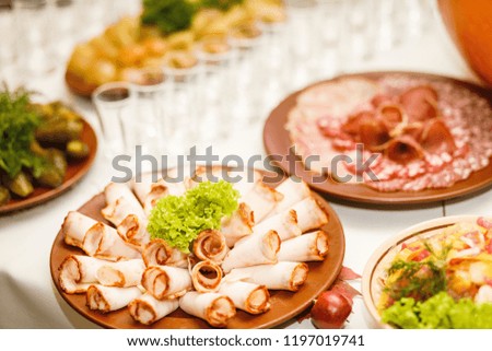 Autumn composition. Misted decanter of vodka and traditional Ukrainian snack. Beautifully decorated catering banquet table with different food snacks