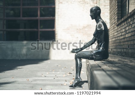 Useless mannequin. Old plastic mannequin with only one leg and one arm looking broken and useless