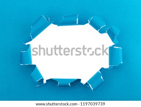 Blue ripped open paper background,space for your message on torn paper