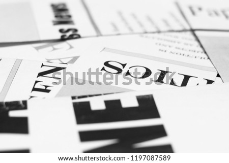 Newspapers with headlines and articles scattered on horizontal surface, side view,  background texture                       