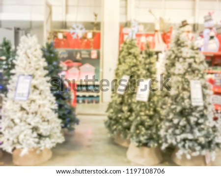Abstract blurred wide selection of artificial Christmas tree multi-color lights at hardware store in Texas, USA. Defocused classic, decorated Xmas color changing wreaths, strings bokeh ornaments