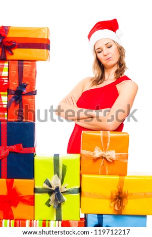 Young satisfied Christmas woman looking at colourful gift boxes, isolated on white background.