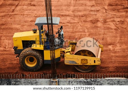 Yellow roller vehicles around a construction site unique photo