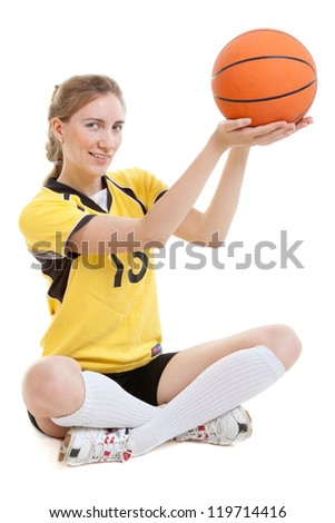 Young female basketball player with ball