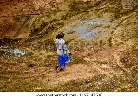 A lady worker walking around a construction site in India unique photo