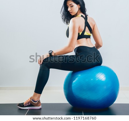 Young fitness woman with blue fitball. Crossfit training. Fitness concept.