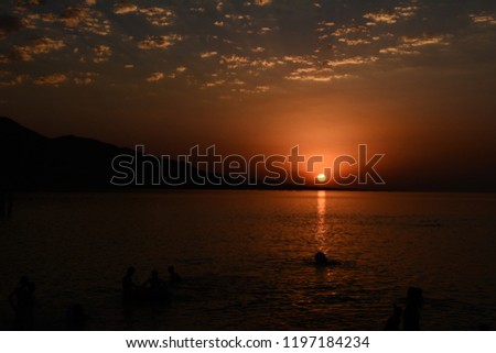 Beautiful blazing sunset landscape at Caspian Sea and orange sky above.